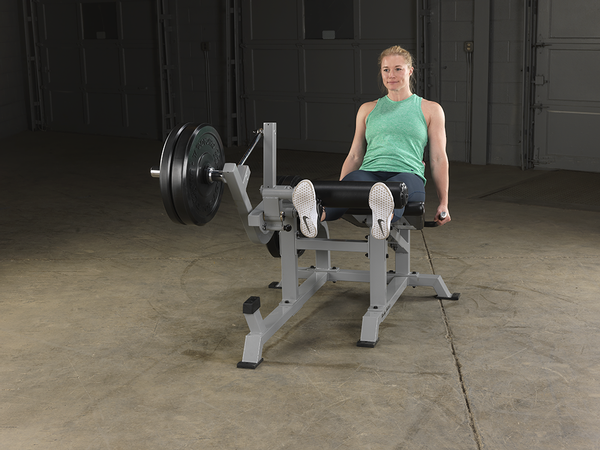 Woman In A Gym Body Solid Leverage Leg Extension Machine