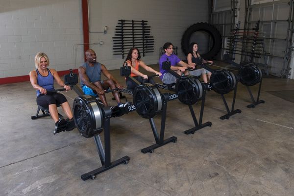 People In A A Gym Using A R300 Rowing Machine