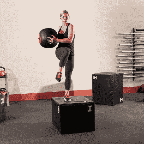 Woman With A Medicine Ball On a Plyo Box