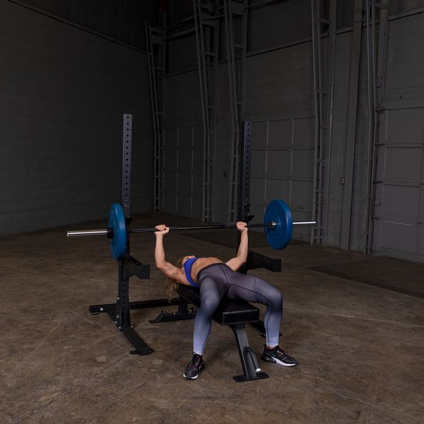 Woman Benching on a Body Solid SPR250 Commercial Squat Stand