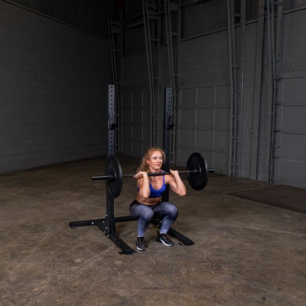 Body Solid SPR250 Commercial Squat Stand Used By A Woman Working Out